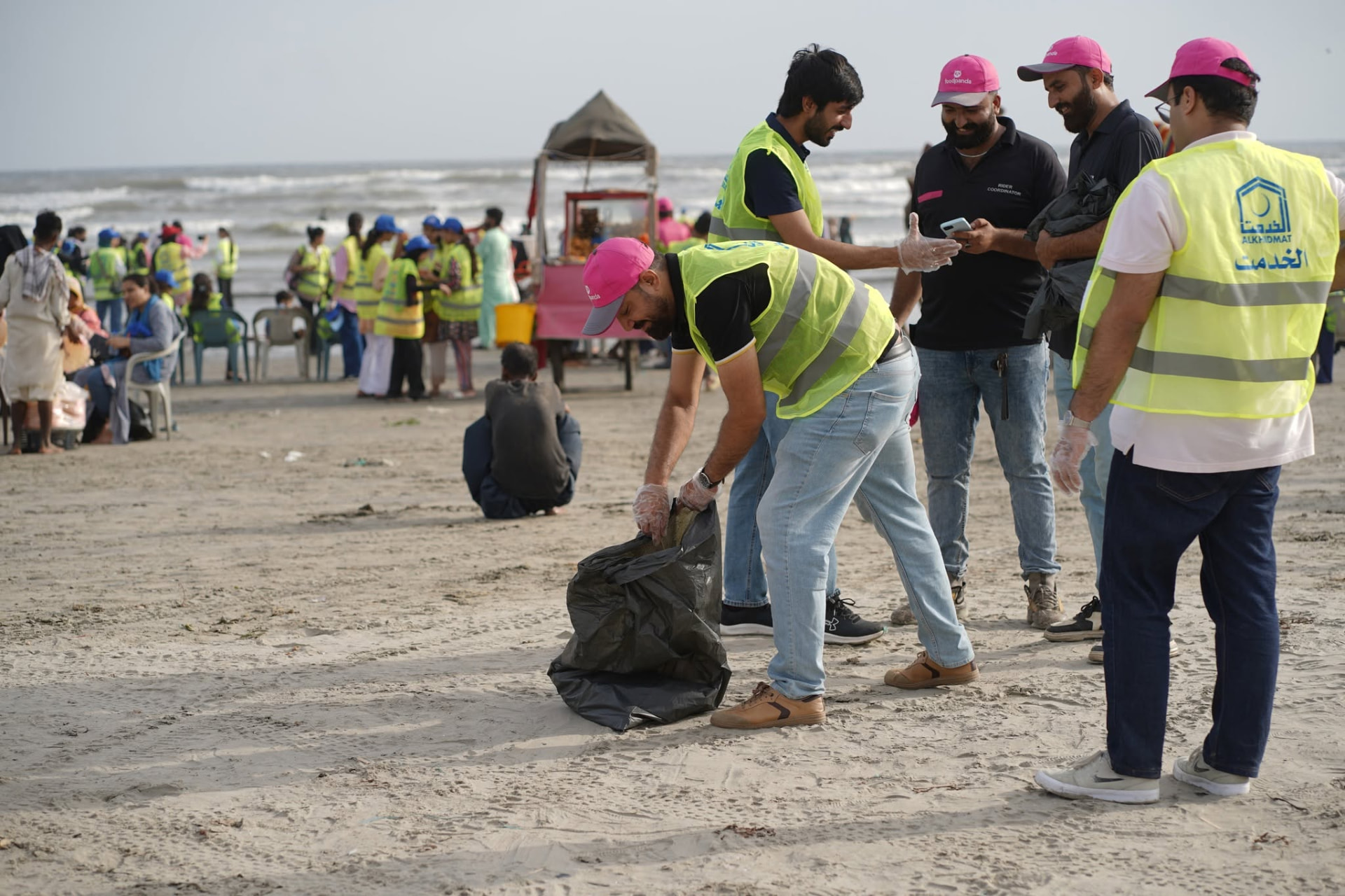 Volunteers collecting waste during a Karachi beach cleaning drive
